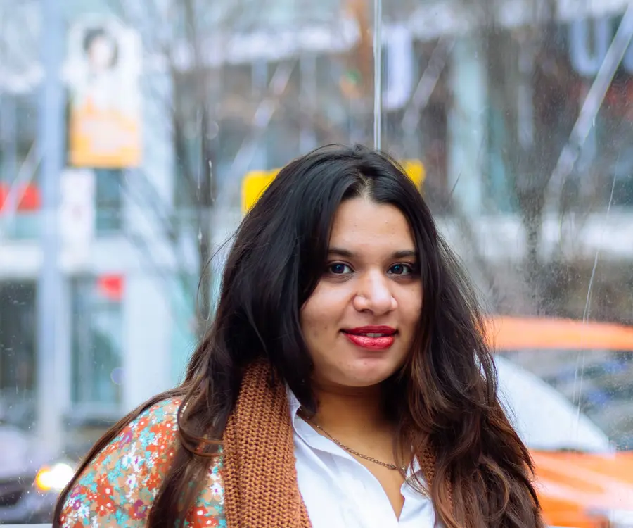 A smiling student on a Toronto street in winter